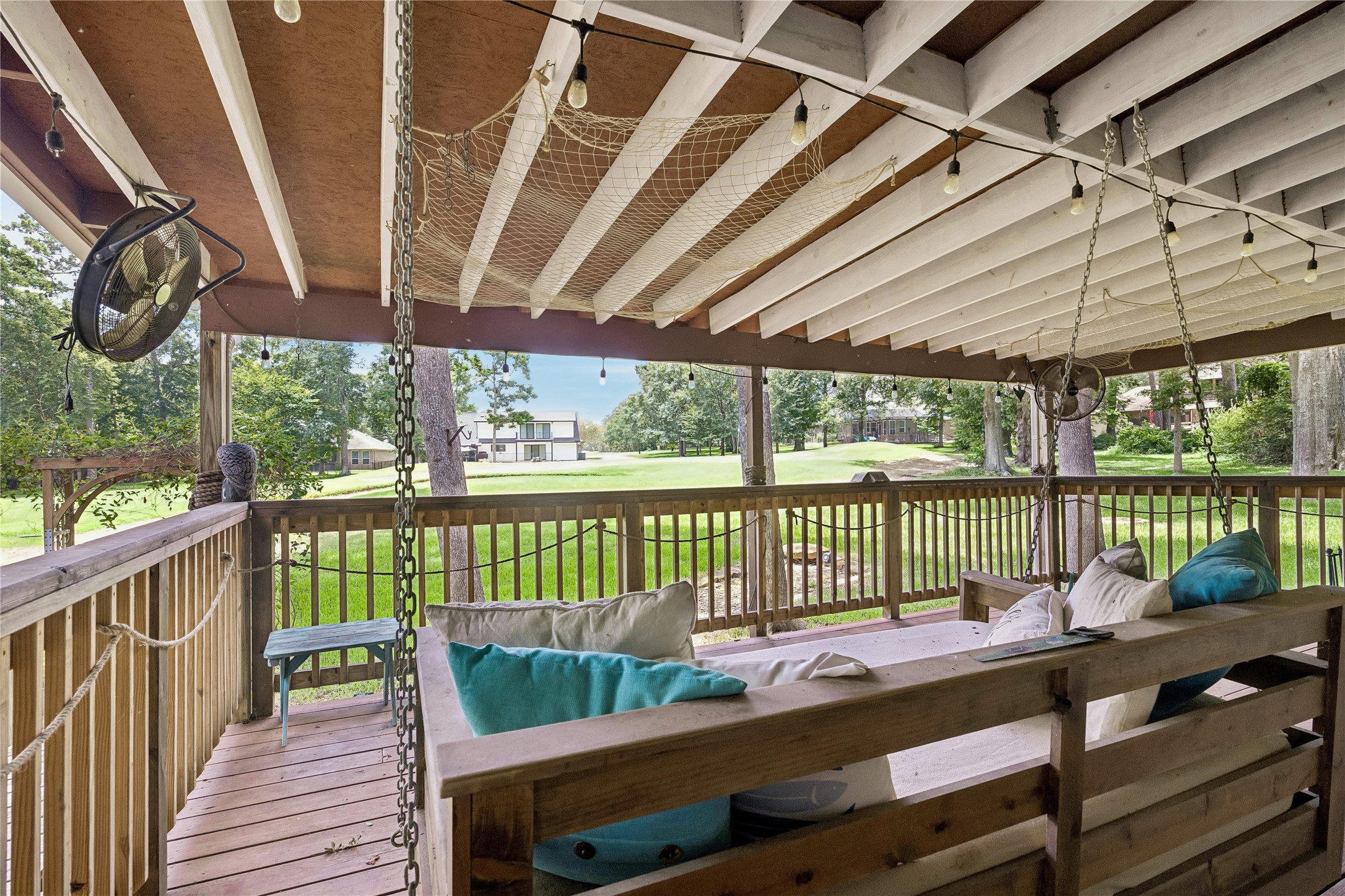 154 7 Coves Road Conroe, TX 77304 - Photo 29 of 32 Back deck has bed swing to enjoy the views!