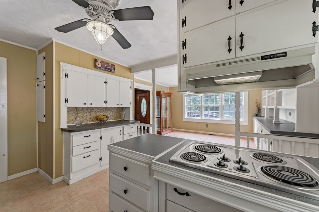 16 Hollow Springs Road Blue Ridge, GA 30513 - Photo 32 of 62 a kitchen with granite countertop a stove cabinets and window