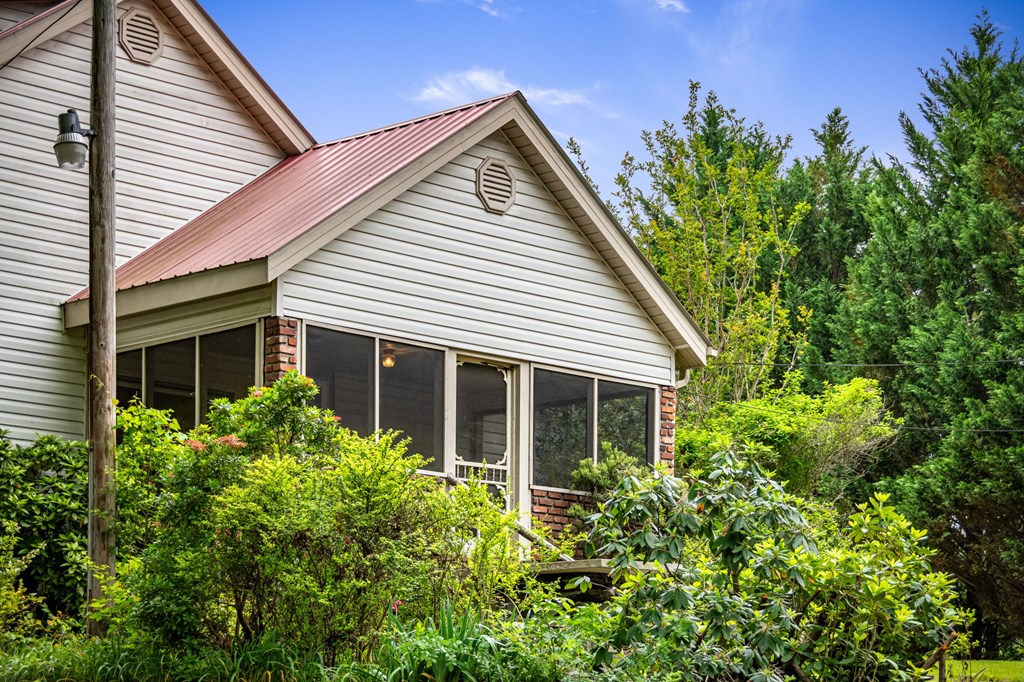 16 Hollow Springs Road Blue Ridge, GA 30513 - Photo 60 of 62 a view of a house with potted plants and more windows