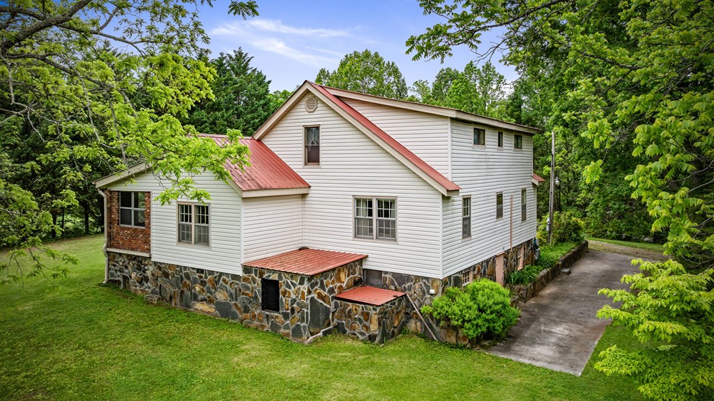 16 Hollow Springs Road Blue Ridge, GA 30513 - Photo 10 of 62 a view of a house with a yard chairs and table