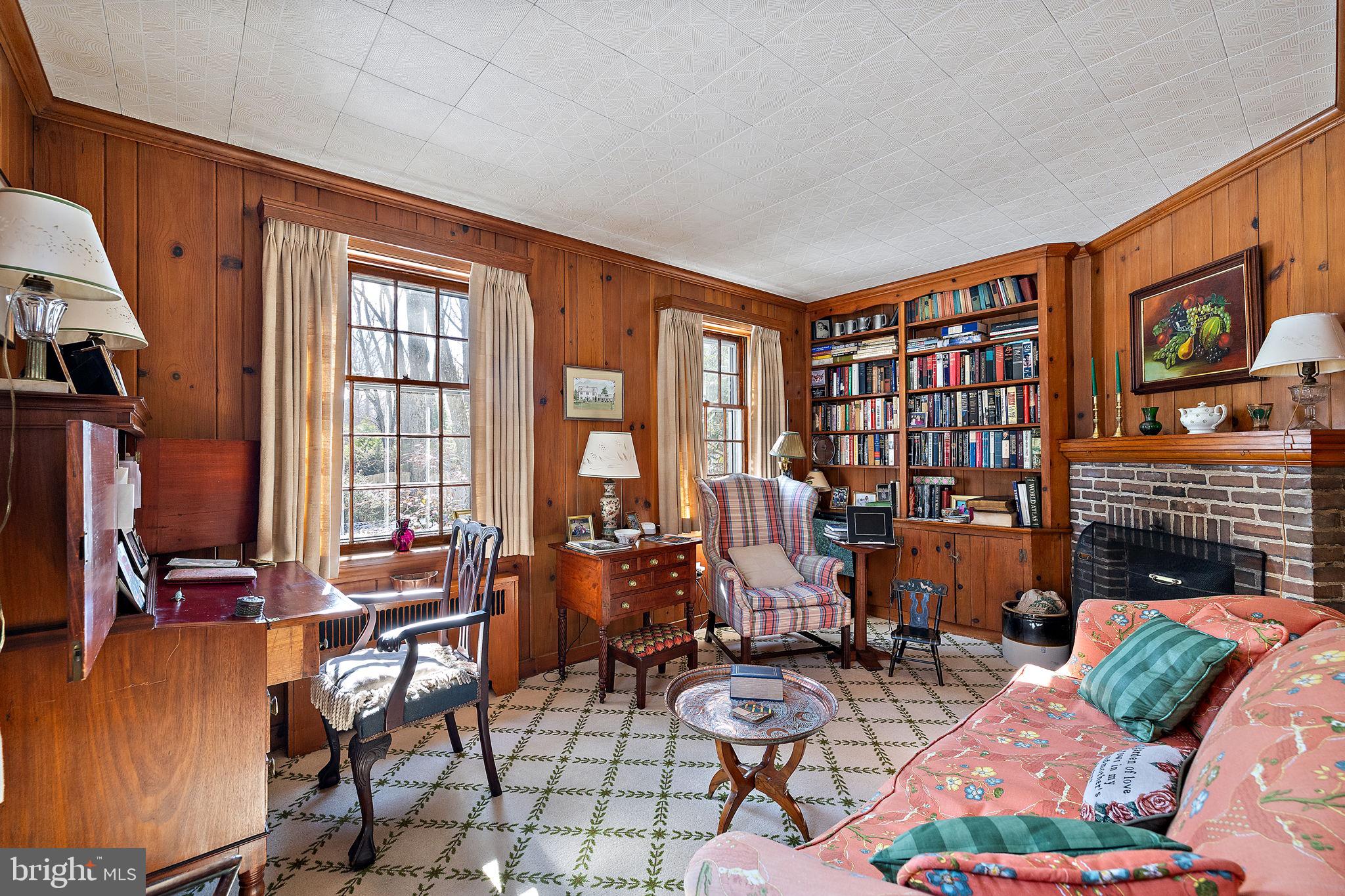 4615 Weldin Road Wilmington, DE 19803 - Photo 15 of 49 a living room with furniture a fireplace and a flat screen tv