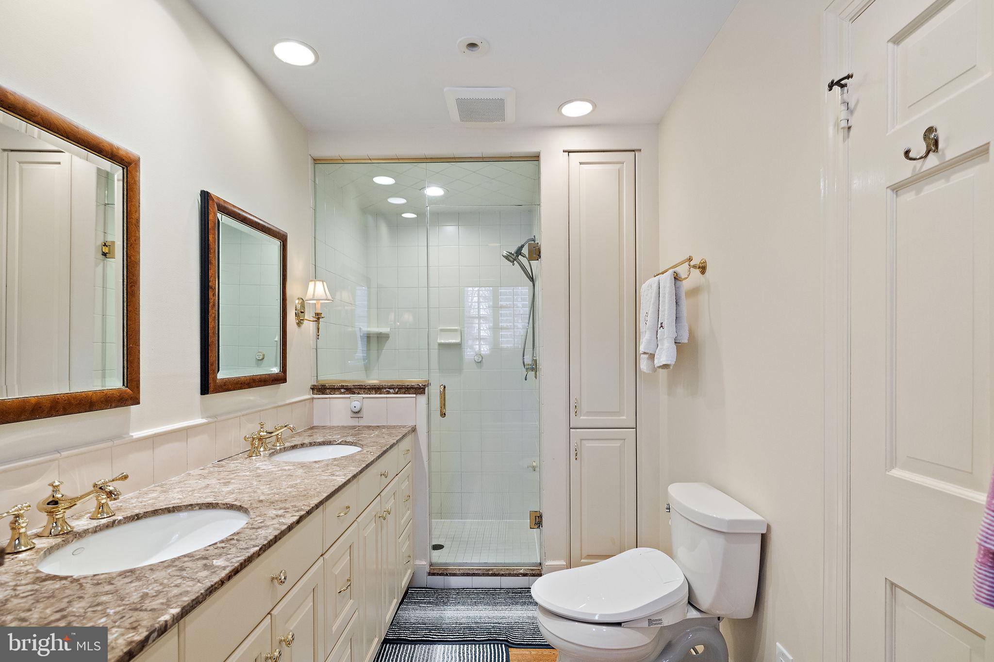 4615 Weldin Road Wilmington, DE 19803 - Photo 30 of 49 a bathroom with a granite countertop sink toilet a large mirror a shower and a bathtub