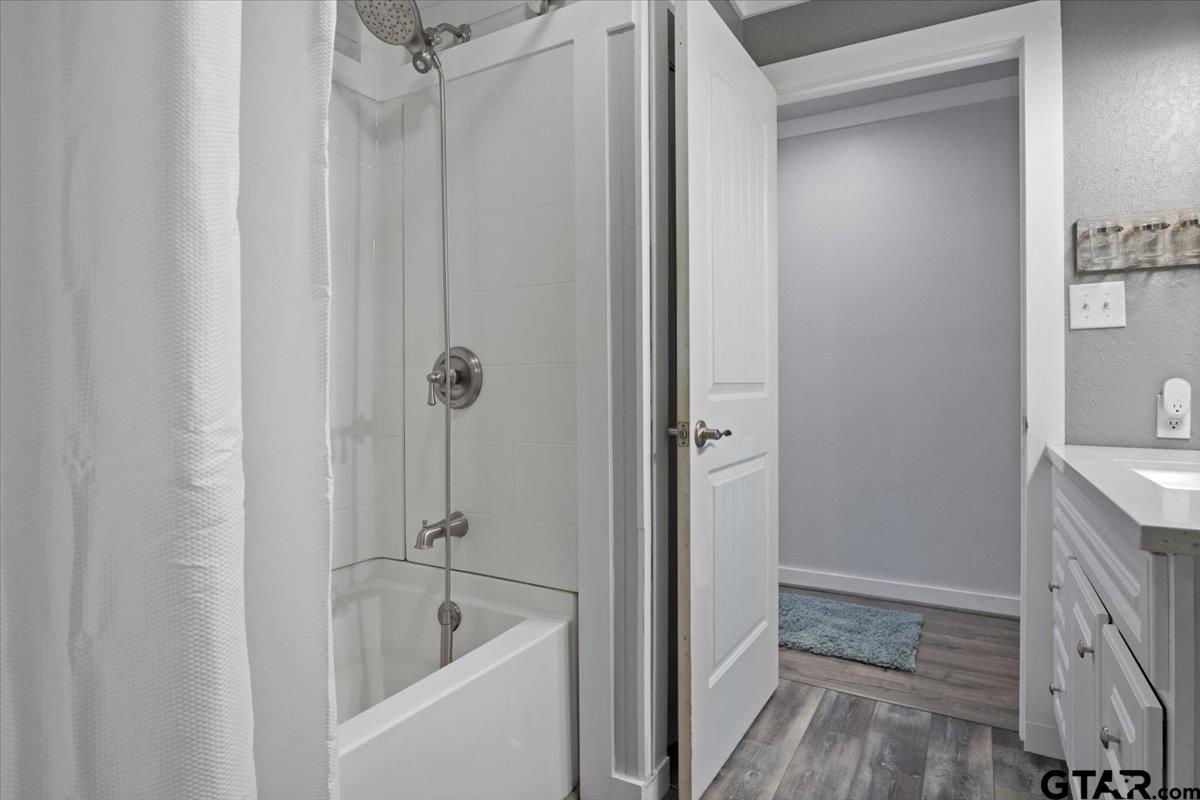 594 County Rd NE 2120 Talco, TX 75487 - Photo 19 of 36 a bathroom with a granite countertop tub sink and shower