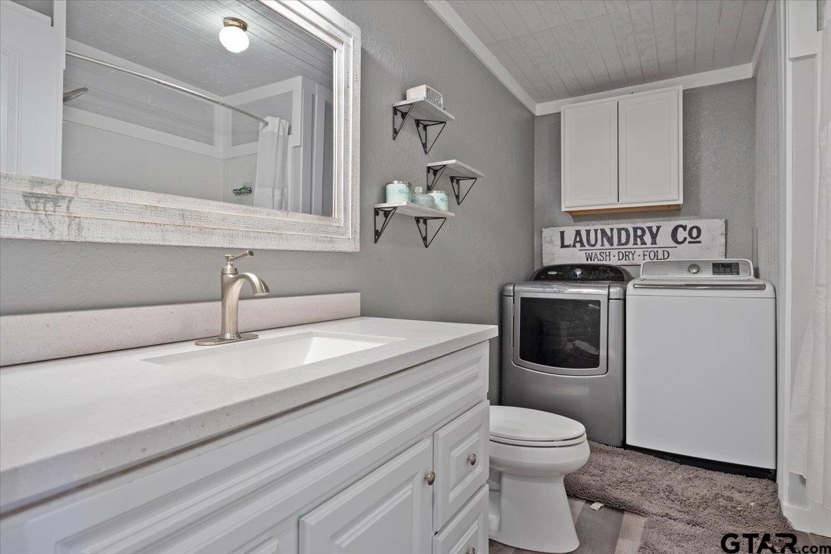 594 County Rd NE 2120 Talco, TX 75487 - Photo 21 of 36 a bathroom with a toilet sink and mirror