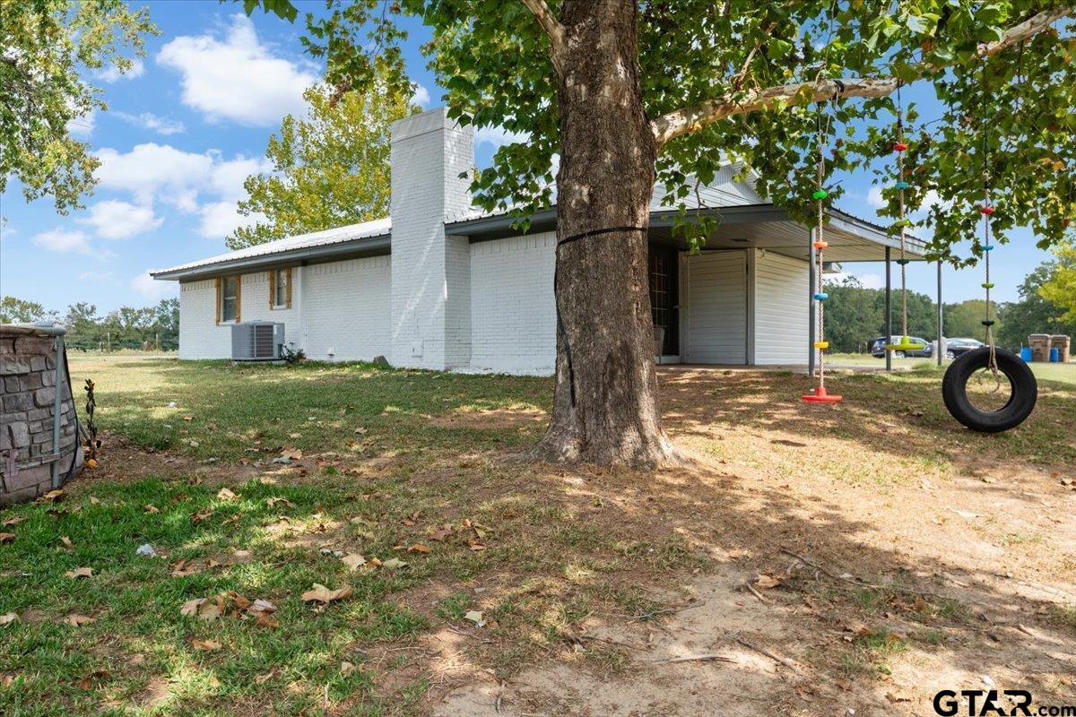 594 County Rd NE 2120 Talco, TX 75487 - Photo 24 of 36 a view of a house with a tree and a yard
