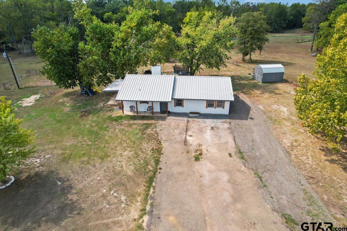 594 County Rd NE 2120 Talco, TX 75487 - Photo 35 of 36 a view of a yard with plants and large trees