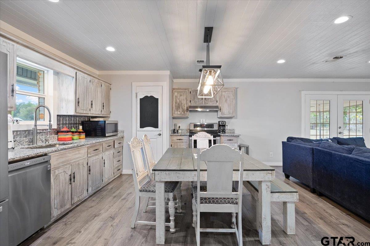 594 County Rd NE 2120 Talco, TX 75487 - Photo 10 of 36 a kitchen with granite countertop a center island and stainless steel appliances