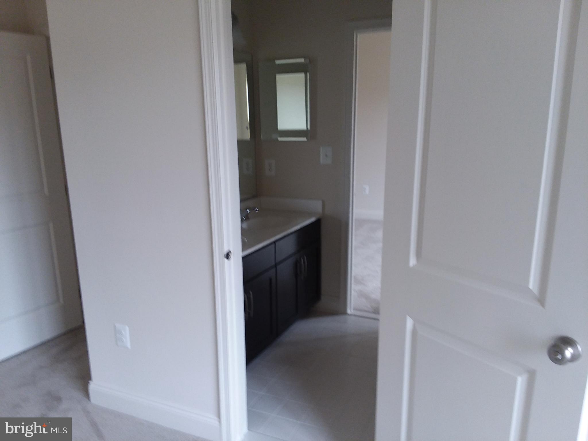 22595 Windsor Locks Square Ashburn, VA 20148 - Photo 17 of 56 a view of hallway with washer and dryer
