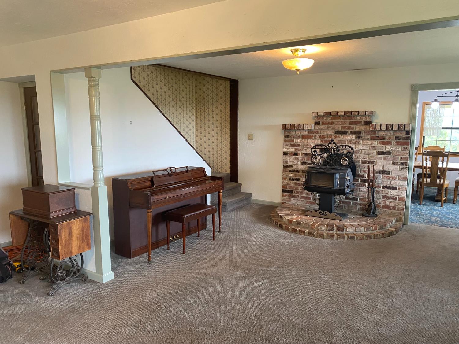 5021 Banbury Cross Road Shingle Springs, CA 95682 - Photo 36 of 92 View to the living room and wood burning stove from the family room (where the bay window is) towards the dining area and the stair case that leads to the 2nd floor.