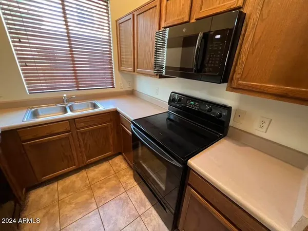 a kitchen with stainless steel appliances a refrigerator and a counter top space