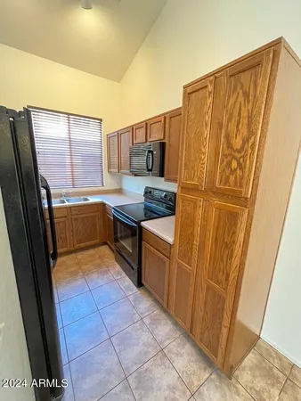 a kitchen with stainless steel appliances a sink stove and cabinets