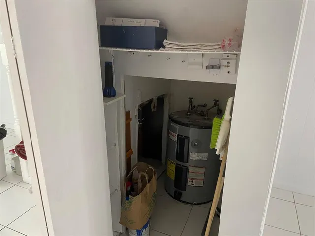 a view of a house with a yard and a large tree