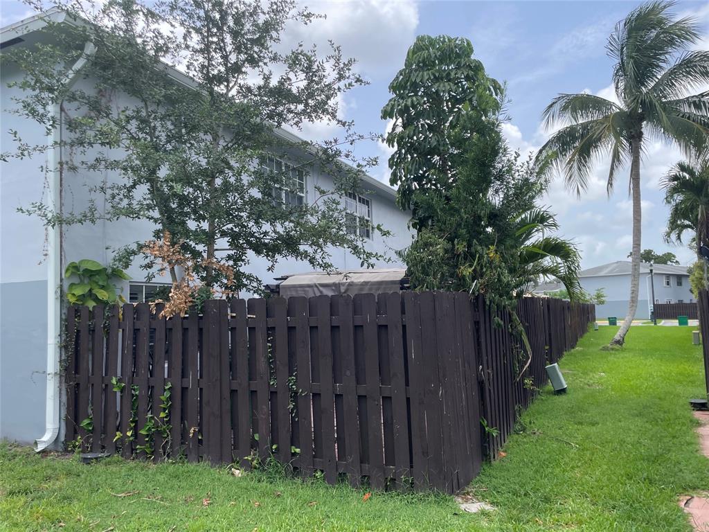 1775 Southwest 81st Way Davie, FL 33324 - Photo 24 of 35 a view of a backyard with wooden fence and a large tree