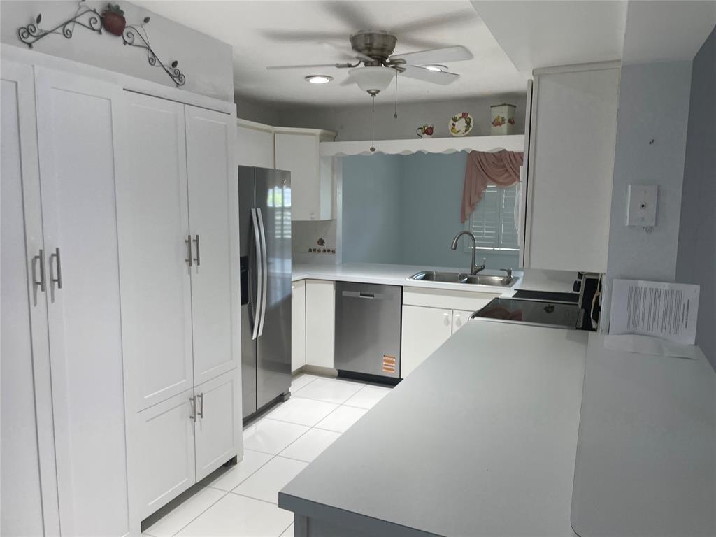 1775 Southwest 81st Way Davie, FL 33324 - Photo 32 of 35 a large white kitchen with a sink stainless steel appliances and cabinets