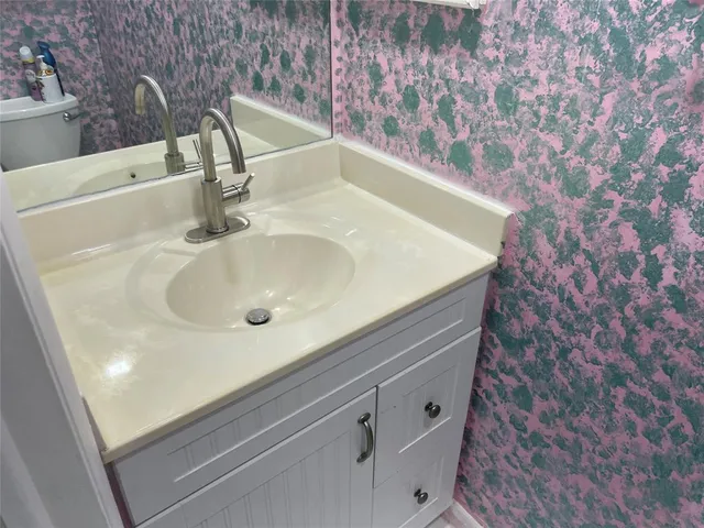 a bathroom with a sink and a large mirror