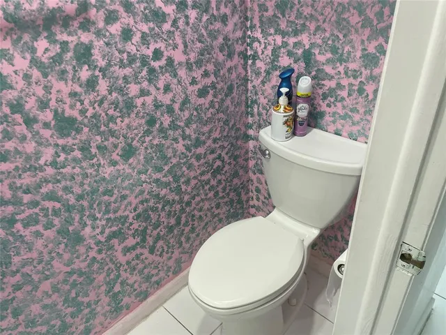 a white toilet sitting next to a shower curtain