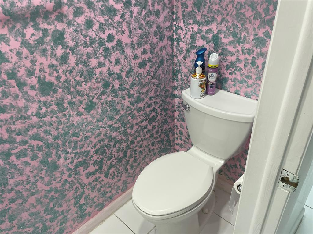 1775 Southwest 81st Way Davie, FL 33324 - Photo 9 of 35 a white toilet sitting next to a shower curtain
