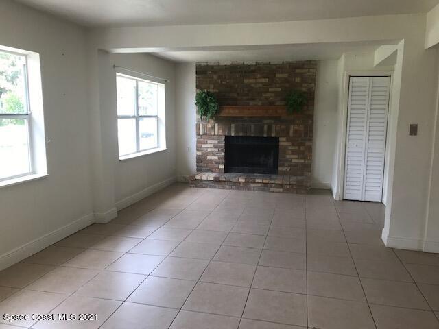 2545 2nd Avenue Northeast Palm Bay, FL 32905 - Photo 2 of 32 an empty room with windows and fireplace