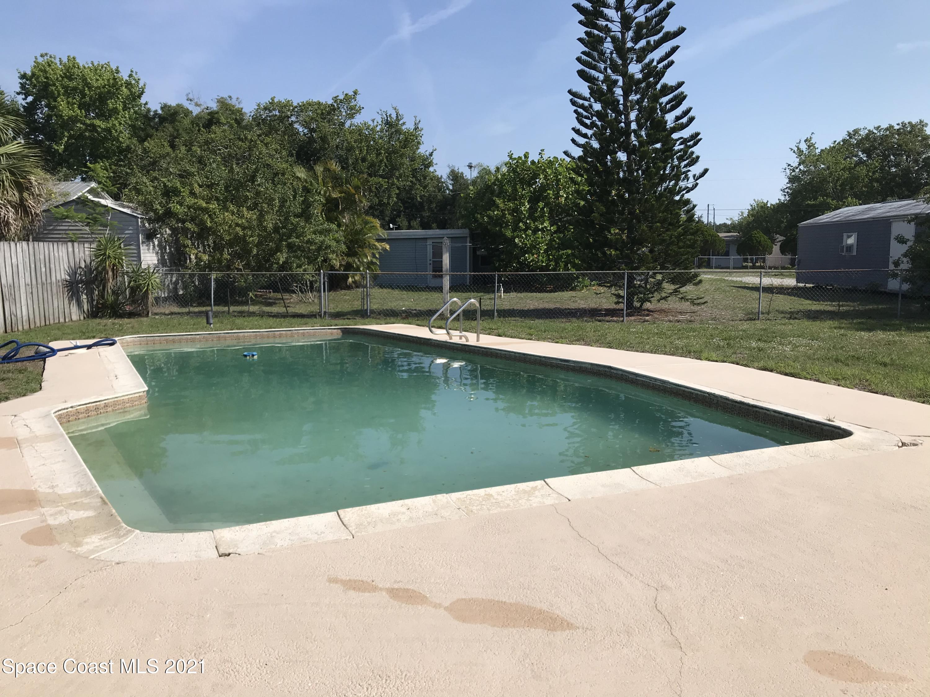 2545 2nd Avenue Northeast Palm Bay, FL 32905 - Photo 14 of 32 a view of a swimming pool with a yard