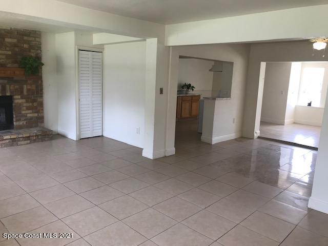 2545 2nd Avenue Northeast Palm Bay, FL 32905 - Photo 3 of 32 an empty room with a fireplace and cabinet