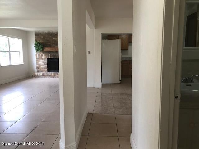 2545 2nd Avenue Northeast Palm Bay, FL 32905 - Photo 22 of 32 a view of a hallway with wooden cabinets and a bathroom