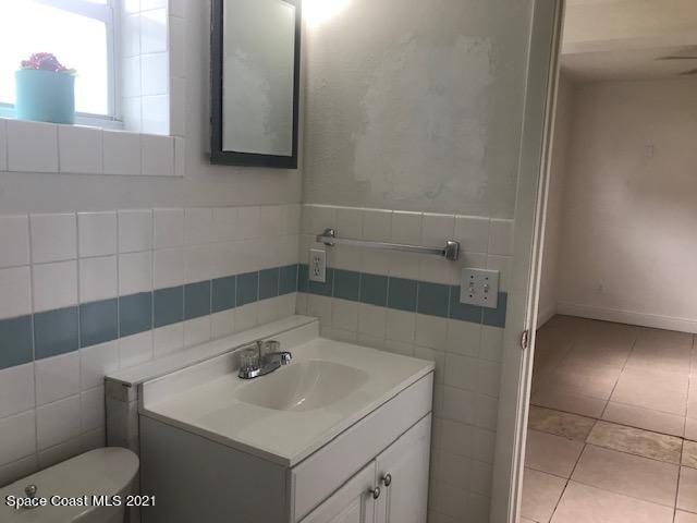 2545 2nd Avenue Northeast Palm Bay, FL 32905 - Photo 24 of 32 a bathroom with a sink and a mirror
