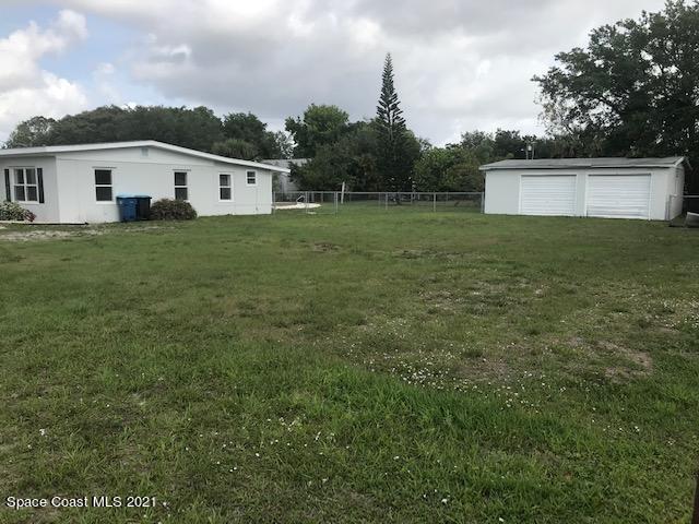 2545 2nd Avenue Northeast Palm Bay, FL 32905 - Photo 31 of 32 a front view of a house with a yard and trees