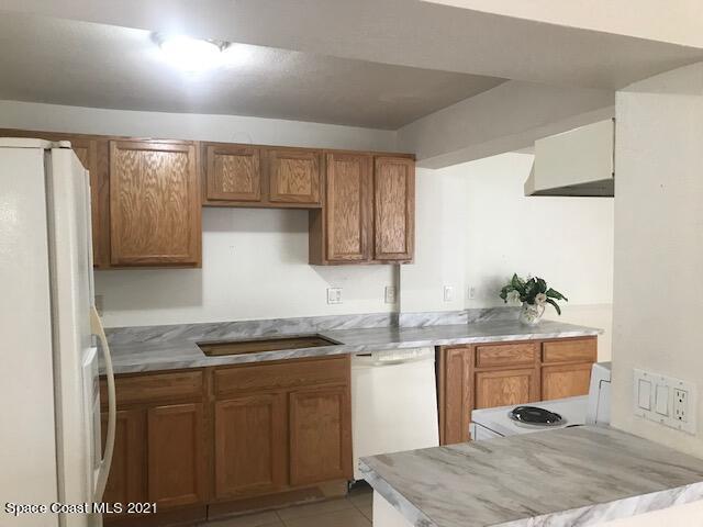 2545 2nd Avenue Northeast Palm Bay, FL 32905 - Photo 5 of 32 a kitchen with a sink cabinets and wooden floor