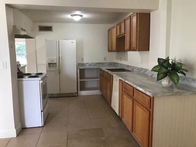 2545 2nd Avenue Northeast Palm Bay, FL 32905 - Photo 7 of 32 a kitchen with stainless steel appliances granite countertop a refrigerator and a sink
