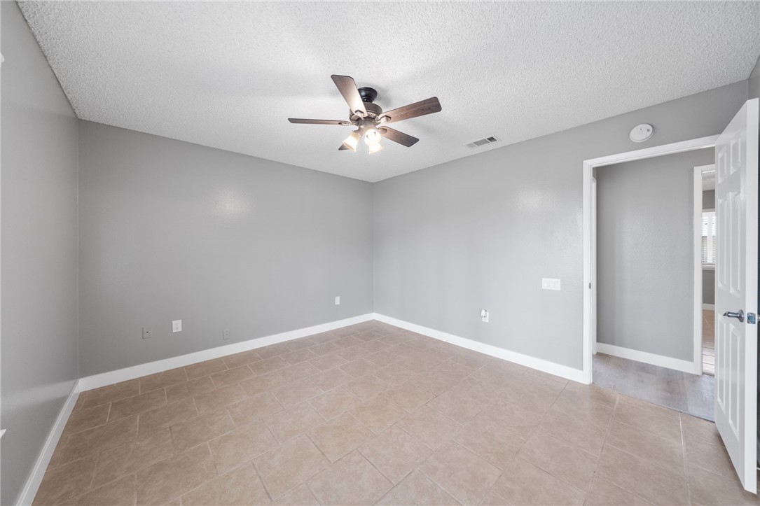 26932 Howard Street Menifee, CA 92586 - Photo 12 of 28 an empty room with chandelier fan and windows