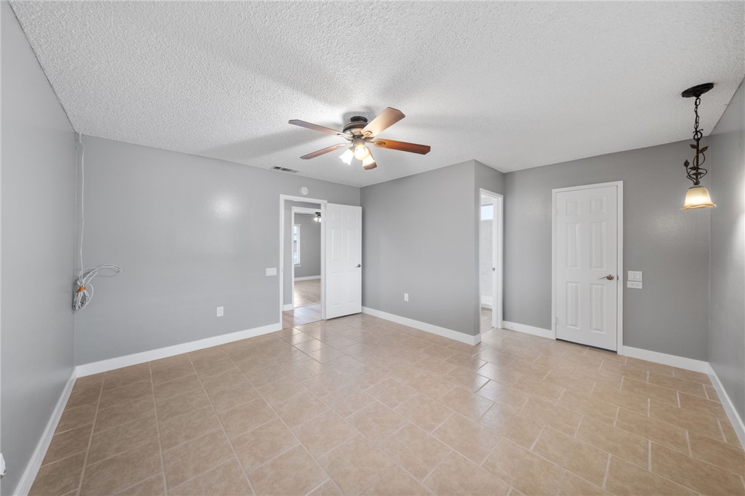 26932 Howard Street Menifee, CA 92586 - Photo 14 of 28 a view of an empty room with a ceiling fan