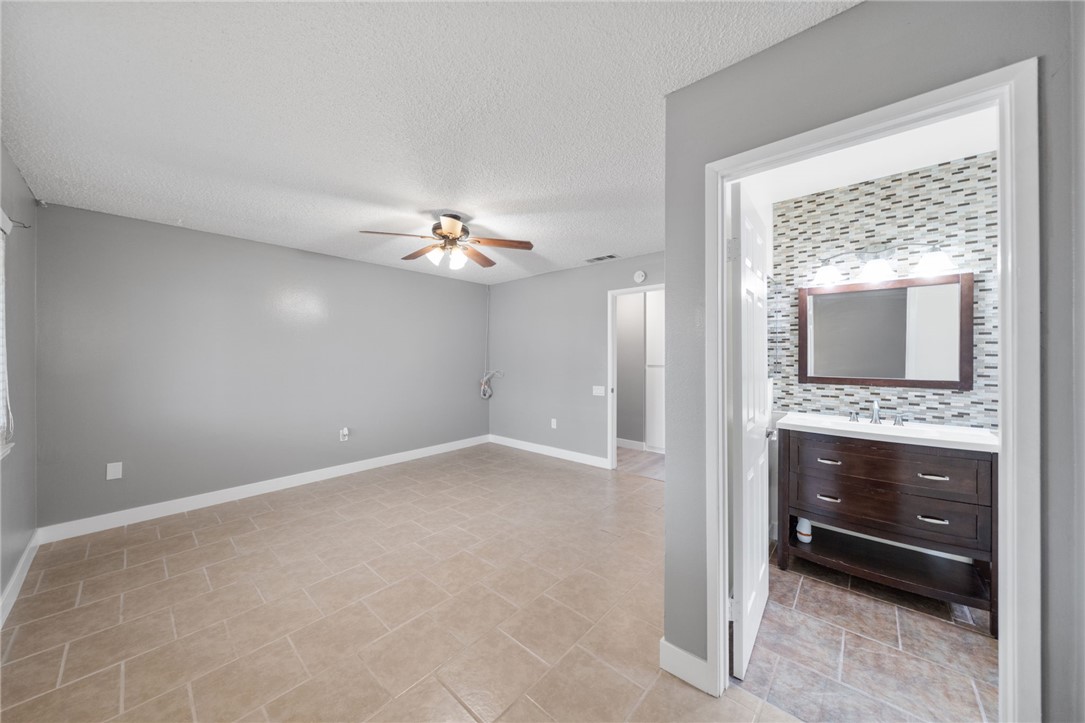 26932 Howard Street Menifee, CA 92586 - Photo 15 of 28 a view of an empty room with a fireplace and a mirror