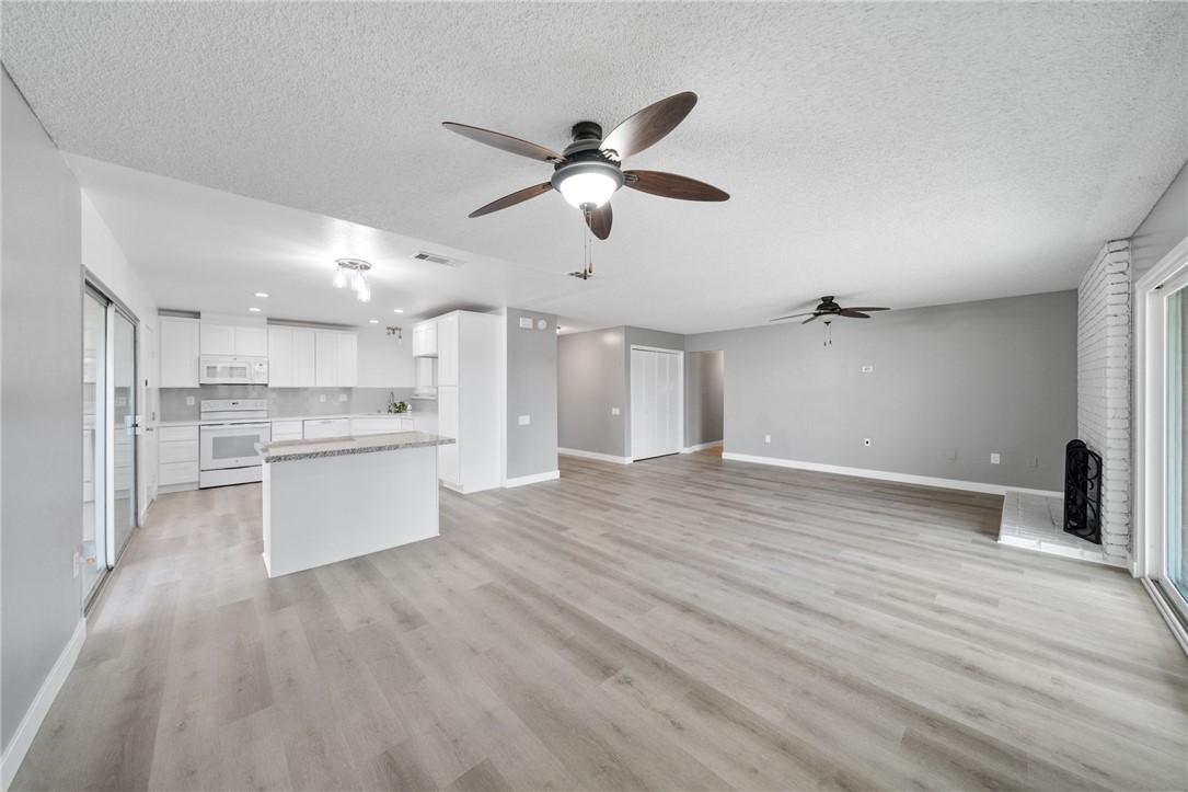 26932 Howard Street Menifee, CA 92586 - Photo 6 of 28 a view of a kitchen with wooden floor and a kitchen
