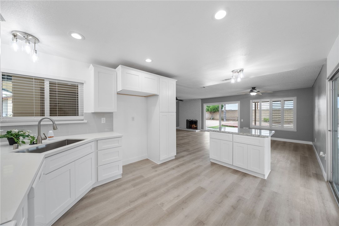 26932 Howard Street Menifee, CA 92586 - Photo 8 of 28 a large kitchen with kitchen island a sink stainless steel appliances and cabinets