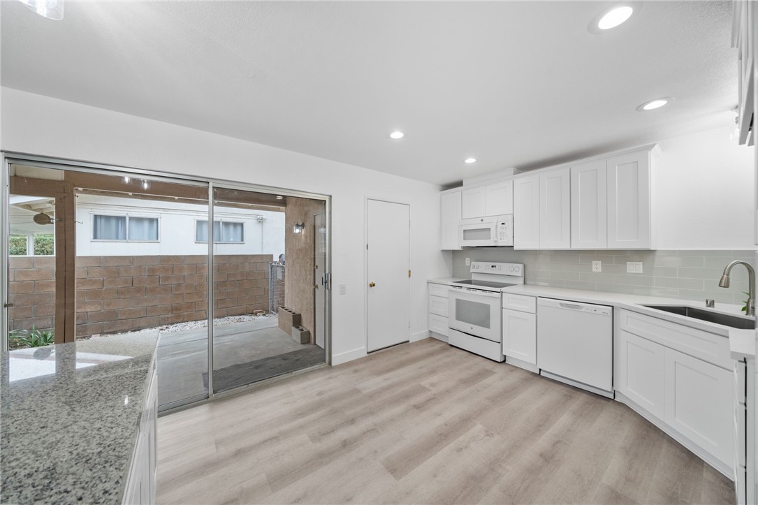 26932 Howard Street Menifee, CA 92586 - Photo 9 of 28 a kitchen with white cabinets and white appliances