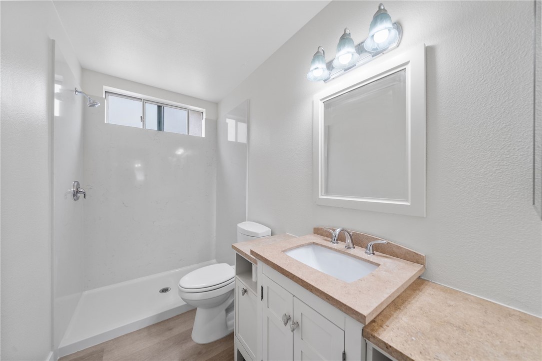 26932 Howard Street Menifee, CA 92586 - Photo 10 of 28 a bathroom with a sink toilet a mirror and shower