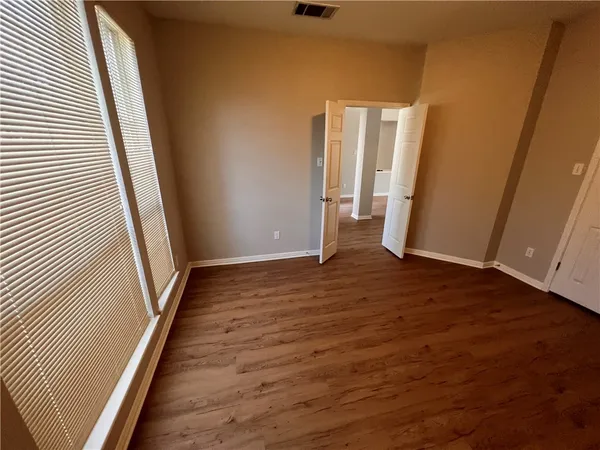 a view of a room with wooden floor and staircase