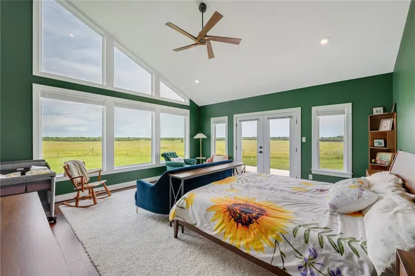 a spacious bedroom with a large window and a bed