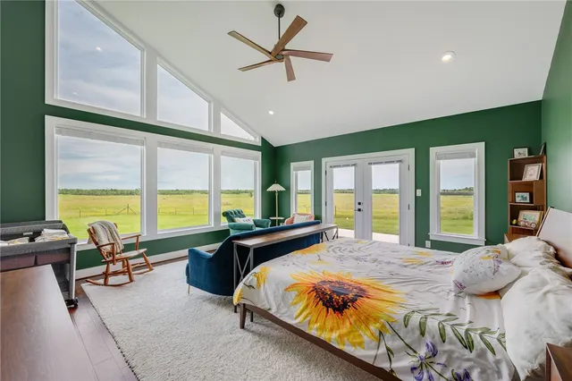 a spacious bedroom with a large window and a bed