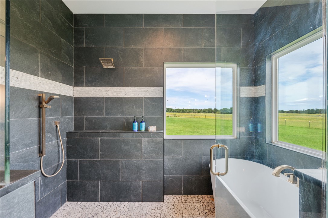 2970 County Road 270 Cameron, TX 76520 - Photo 19 of 50 a bathroom with a bathtub and a shower