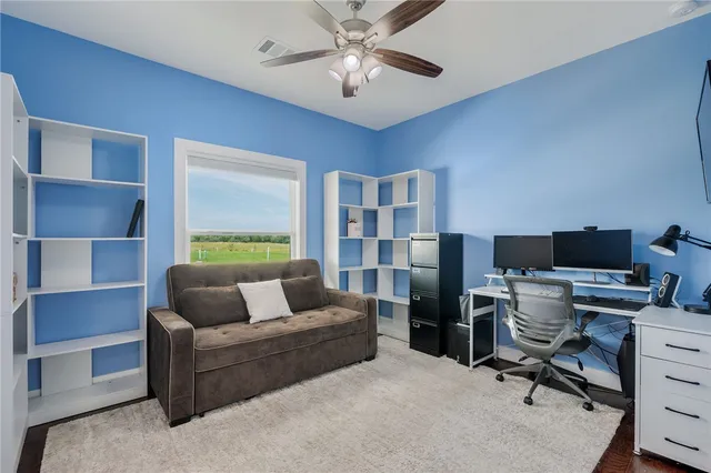 a living room with furniture and a lamp