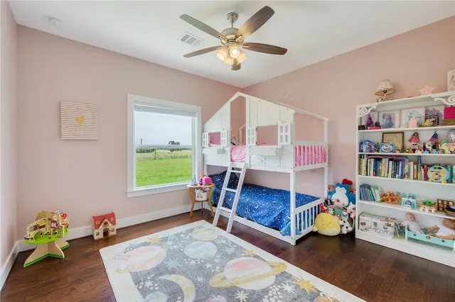 a living room with furniture and a book shelf