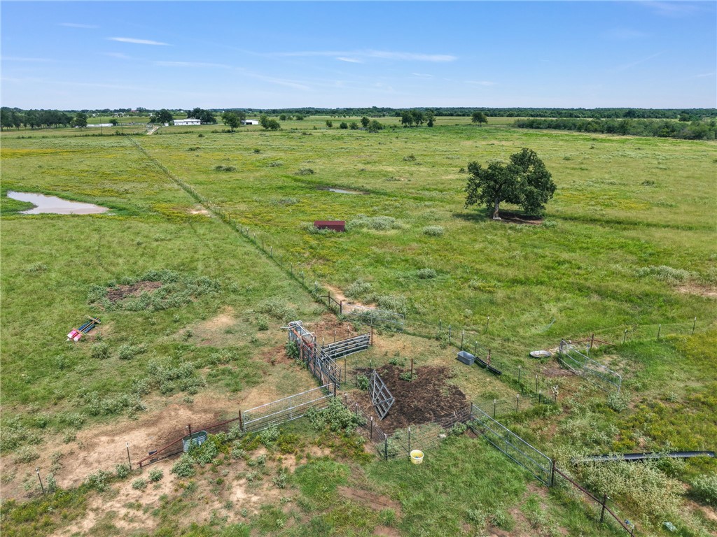 2970 County Road 270 Cameron, TX 76520 - Photo 49 of 50 a view of a field with an ocean and trees in the background