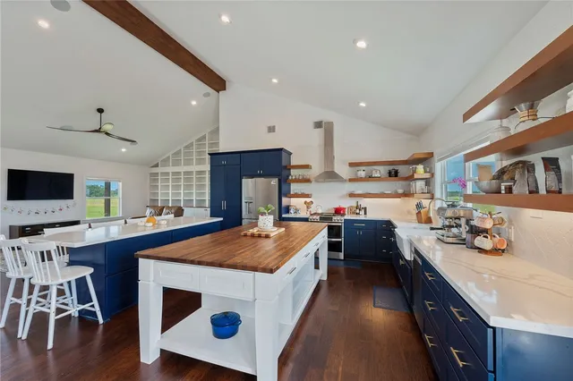 a kitchen with kitchen island a stove a sink and a refrigerator