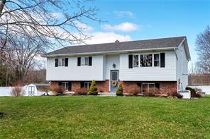 a view of house with backyard