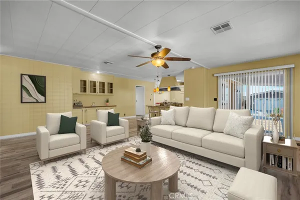 a living room with furniture kitchen view and a rug