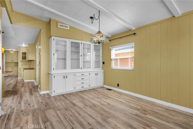 a view of a room with wooden floor and windows