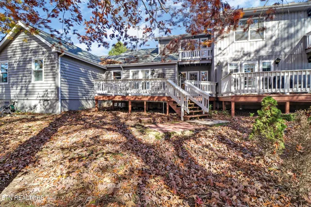 a view of an empty room with wooden floor fireplace and a window