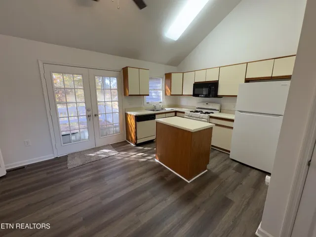a kitchen with stainless steel appliances a stove a sink and a refrigerator