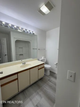 a bathroom with a sink a light fixture and a mirror